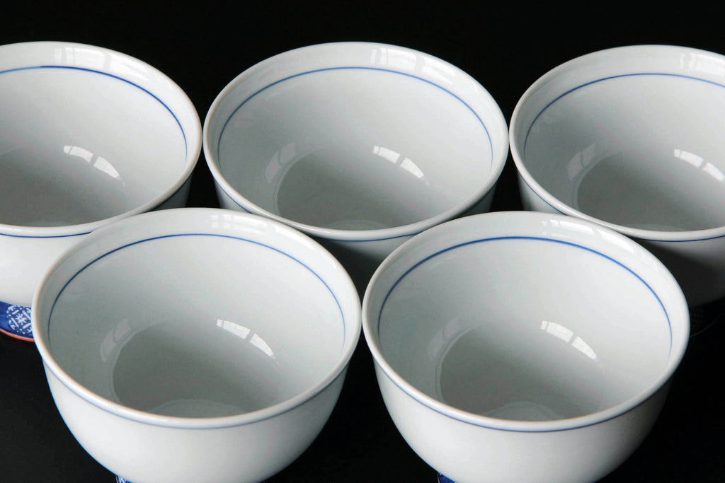 White porcelain tea cup with blue line. Japanese tea ware Arita pottery.
