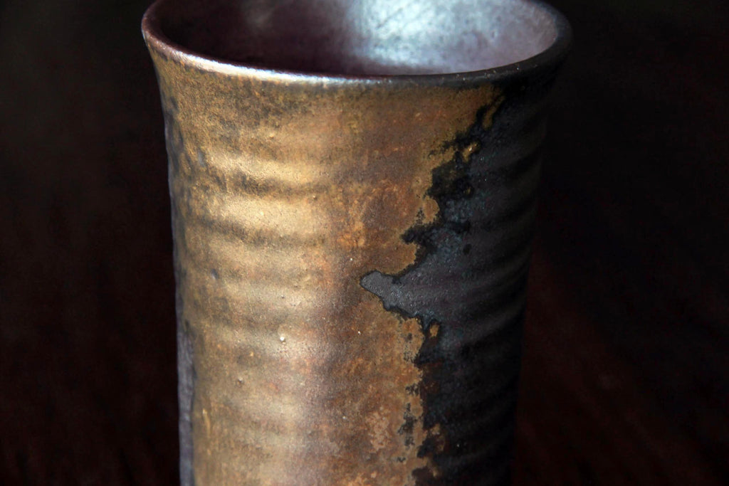 Close-up of the rim and surface texture of a traditional Bizen-yaki mug.