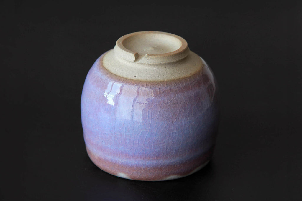Bottom view of a Hagi ware yunomi tea cup showing the unglazed foot and crackled glaze