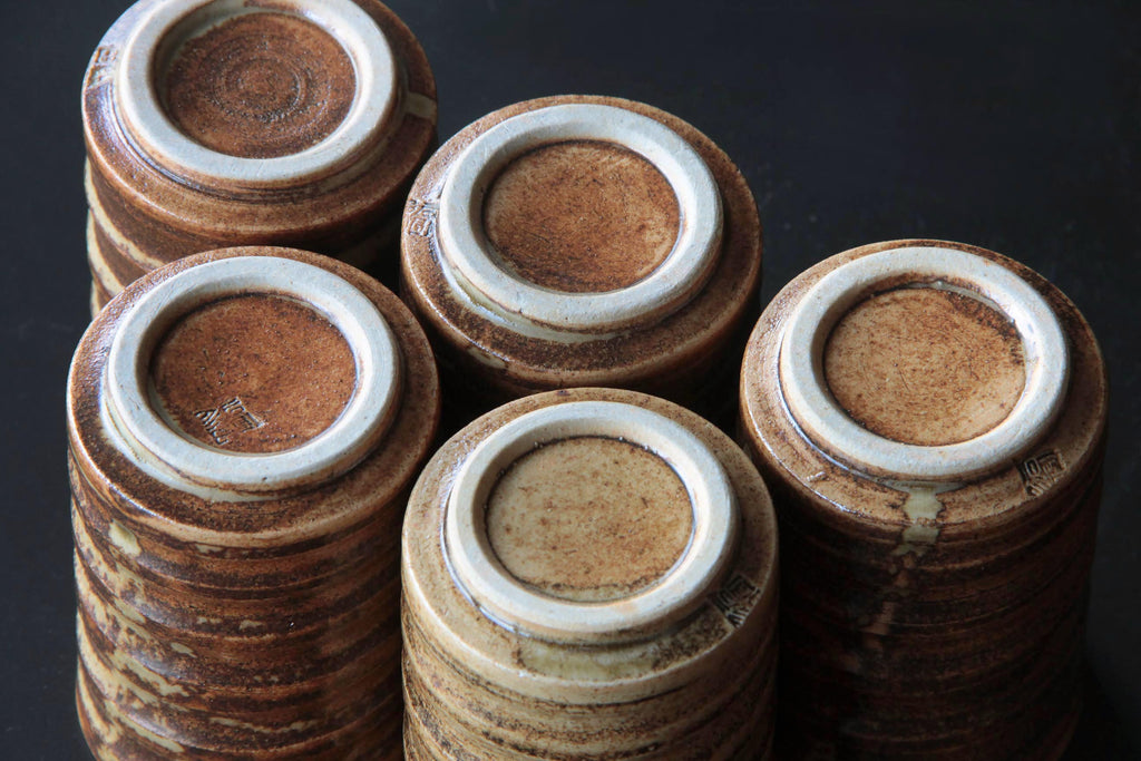 Brown ceramic tea cups. Bottom view