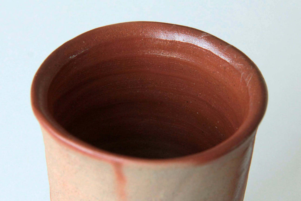 Close-up of the reddish interior surface and fine throwing rings of an unglazed Bizen cup.