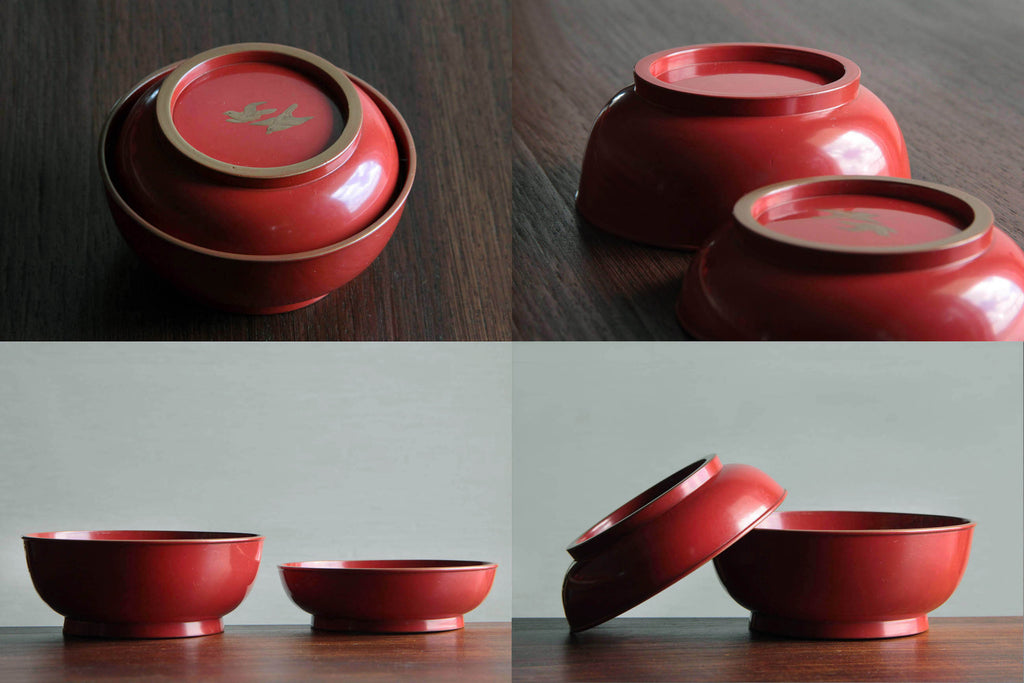 Pair of Japanese red lacquer bowls with Maki-e flower design displayed upright