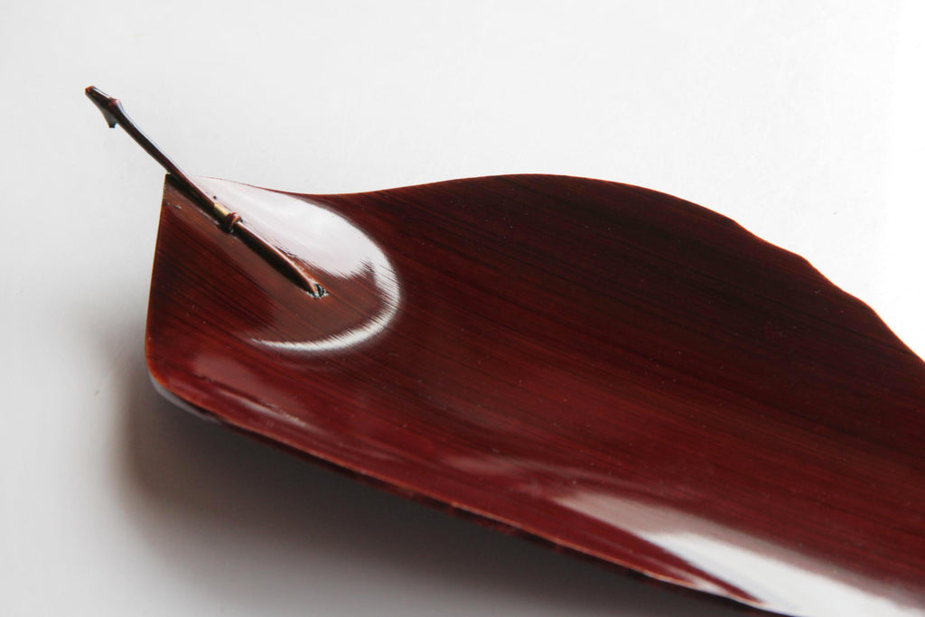 Japanese Hida Shunkei lacquerware plate in the shape of a leaf, used for wagashi or tea ceremony