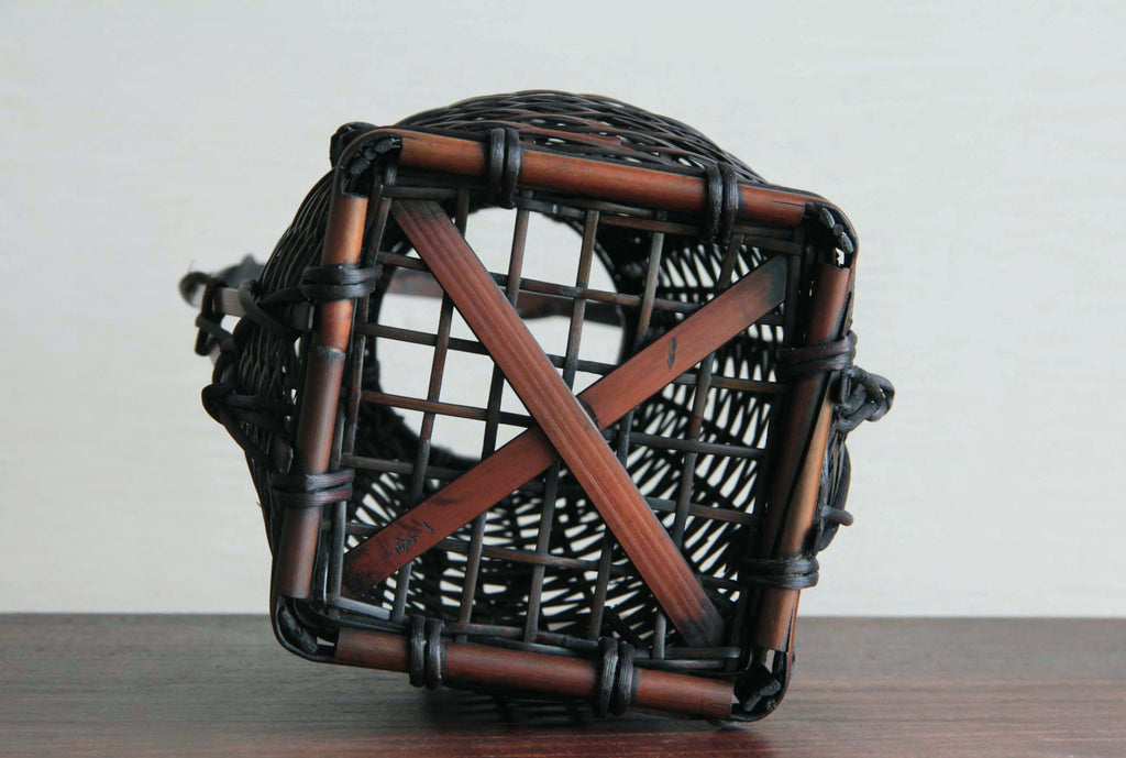 Traditional Japanese bamboo craft vase emphasizing natural patina and precise knot bindings