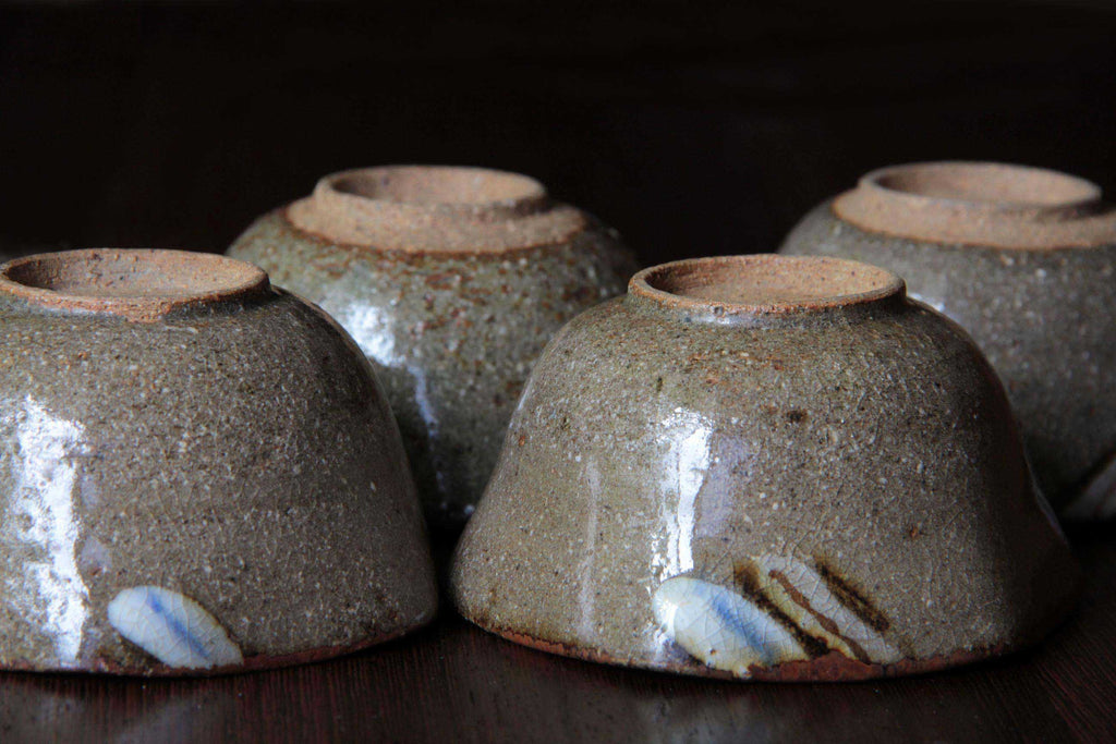Hexagonal Japanese pottery bowl with iron and ash glaze, side view.