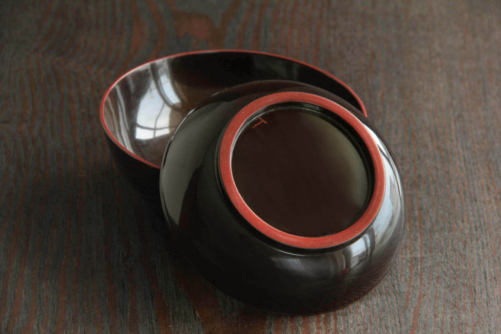 Traditional Japanese soup bowl with urushi lacquer finish and graceful minimalist silhouette