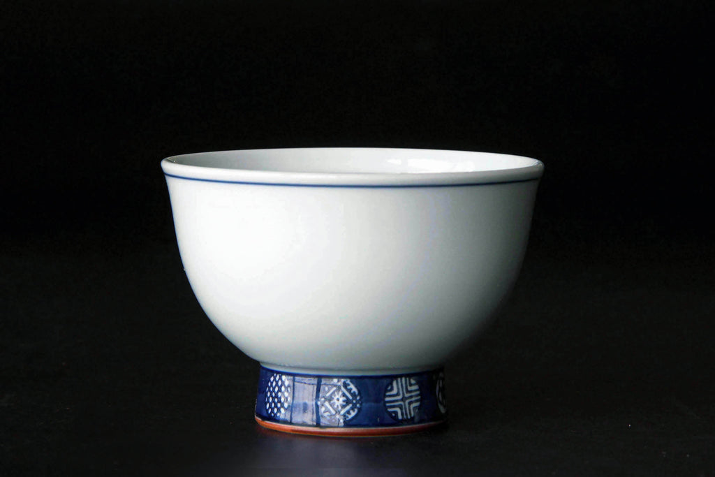 White porcelain tea cup with blue line. Japanese tea ware Arita pottery.