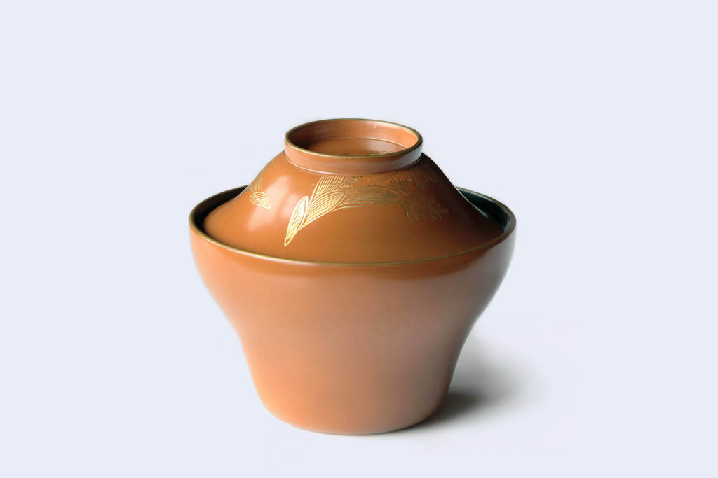 Orange Owan bowl with lid. 