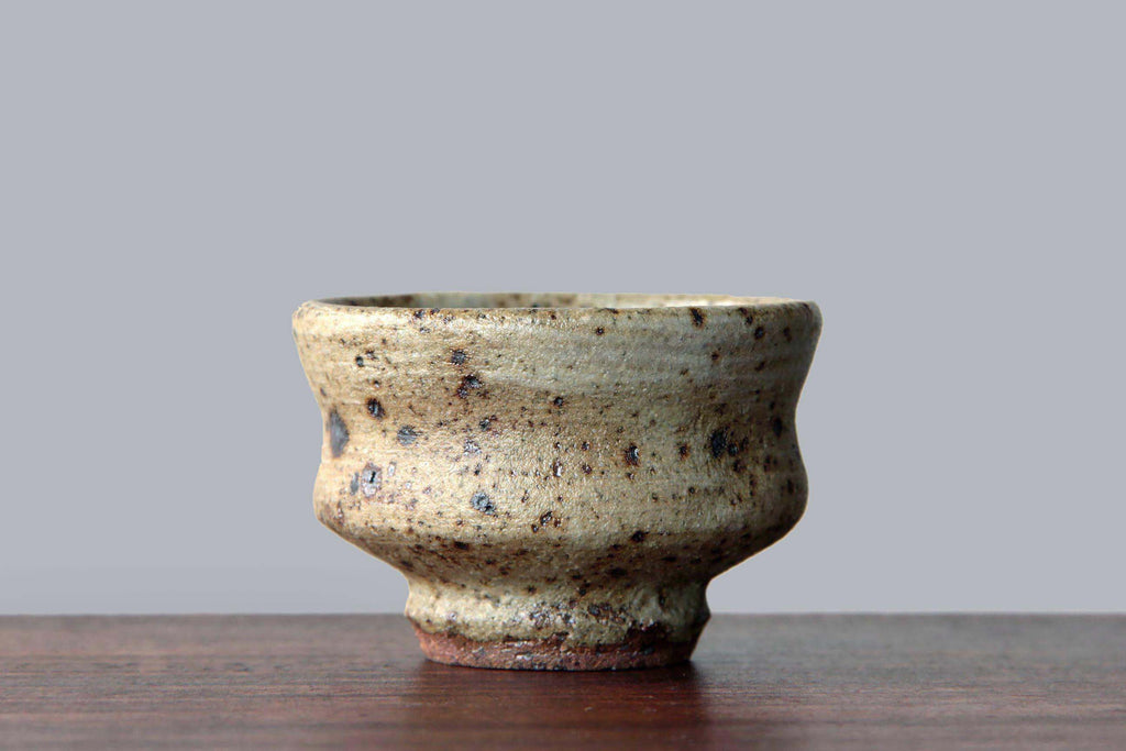Side profile of Mashiko ware sake cup, showing earthy
glaze tones and rough foot.