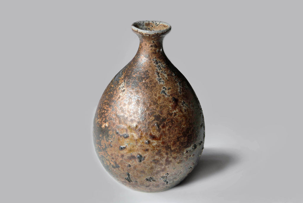 Japanese Bizen ware Tokkuri sake bottle with natural earthy brown tones and kiln firing marks on the surface