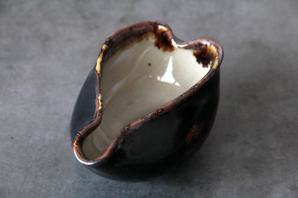 Angled overhead shot focusing on the spout and inner glaze contrast of the yuzamashi