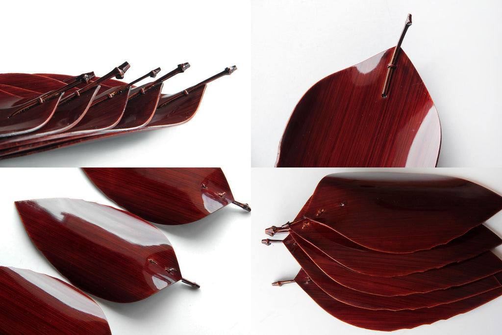 Stacked view of Hida Shunkei lacquer plates with natural wood grain and deep red finish