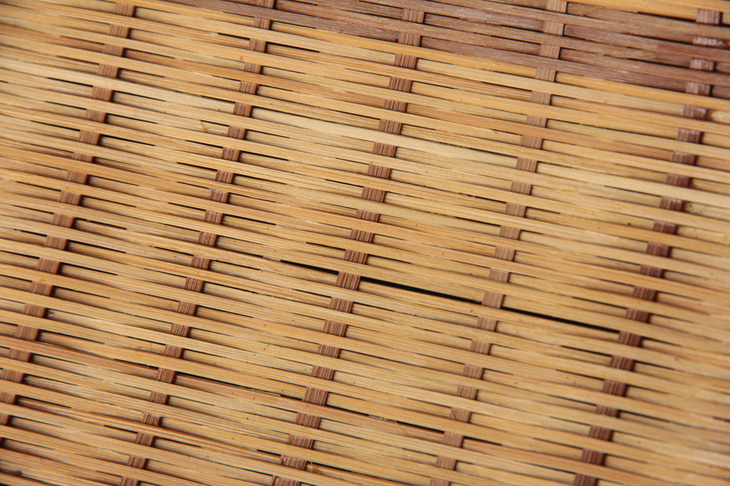 Close-up of the fine hand-woven bamboo pattern showing natural color variations