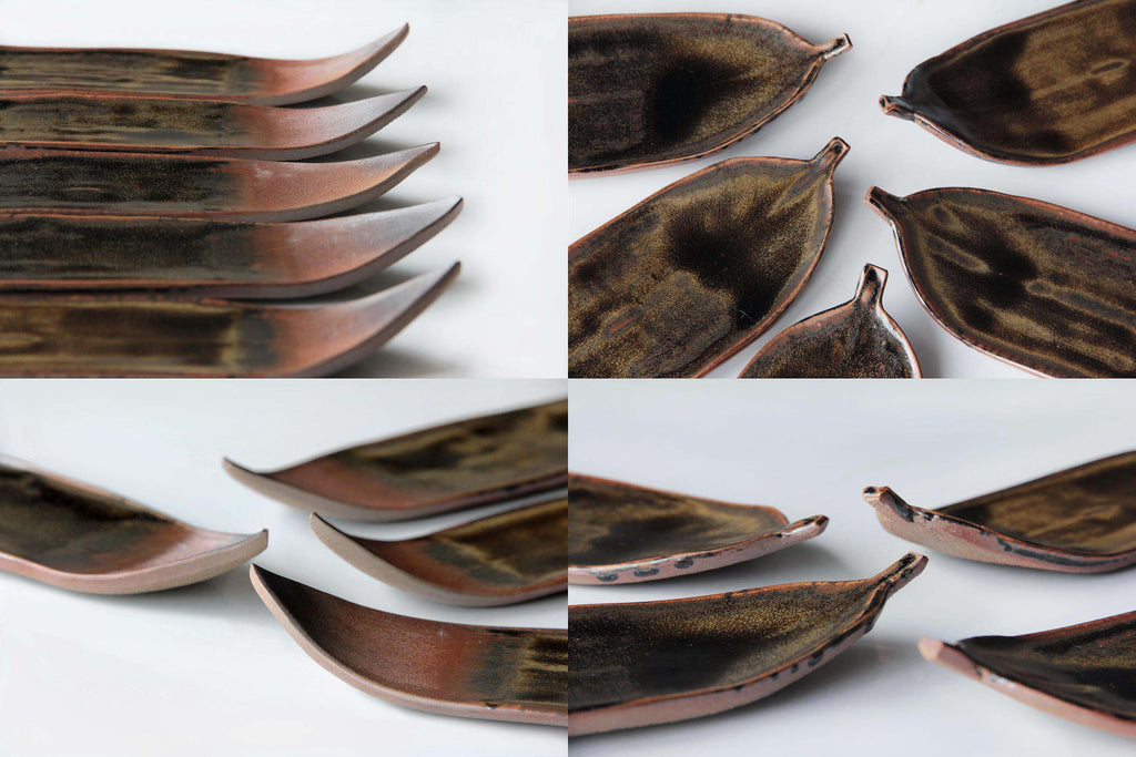 Close-up of Echizen-yaki bamboo leaf plates, highlighting the deep earthy glaze patterns inside
each dish.
