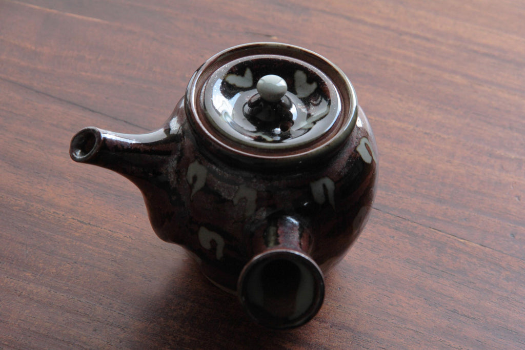 Top view of a traditional Japanese Kyusu teapot with a decorative lid