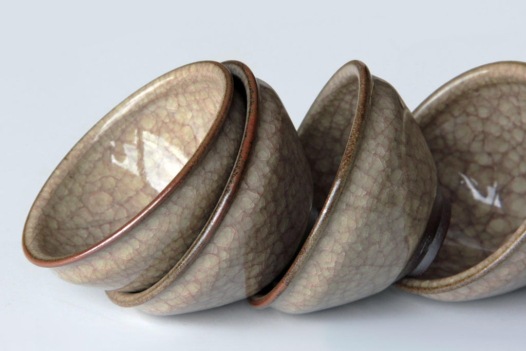 Stacked Japanese crackle glaze tea cups showing glossy surface and natural crazing pattern