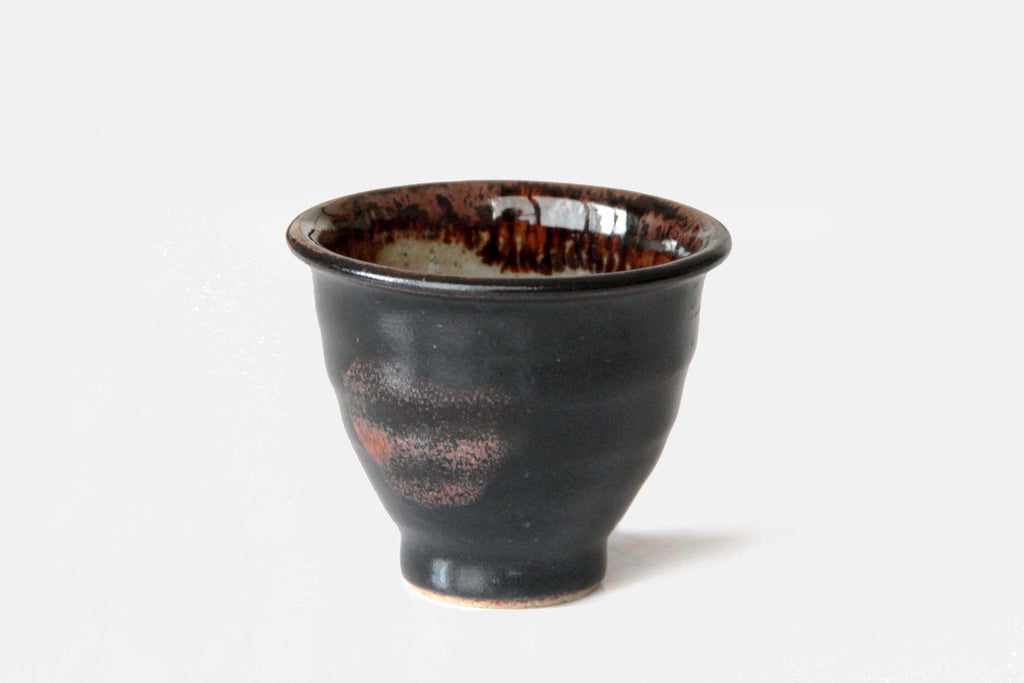 Single Satsuma yunomi tea cup with black glaze and reddish natural firing marks