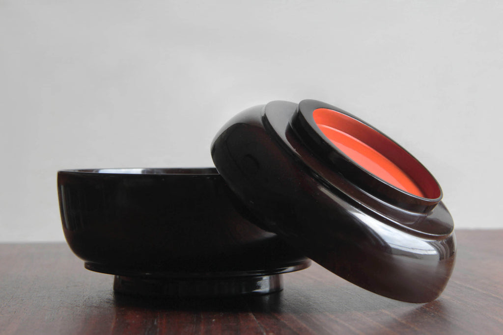 lacquered bowl for miso soup, featuring a striking black and red color scheme.