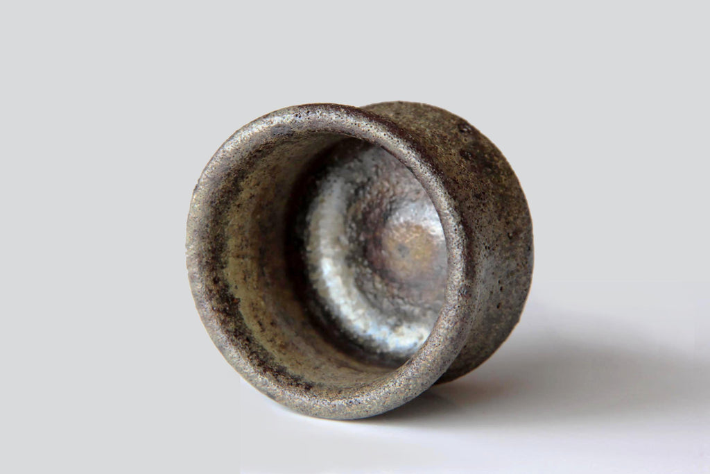 Top view of a Bizen ware sake cup showing its ash-glazed interior and earthy firing marks