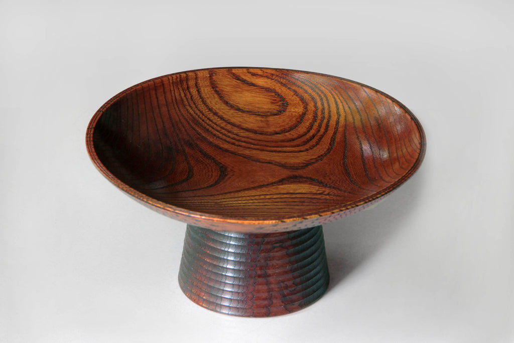 Rim detail showing the fine craftsmanship and curvature of the wooden pedestal bowl.