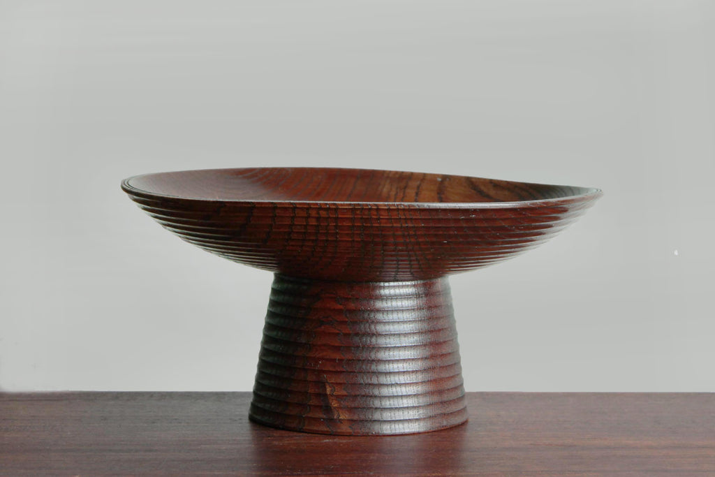 Side profile view of the keyaki wood takatsuki against a white background.