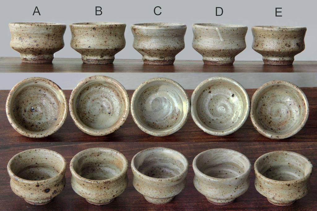 Labeled set of five Mashiko yaki sake cups (A–E), each
with unique glaze variations.