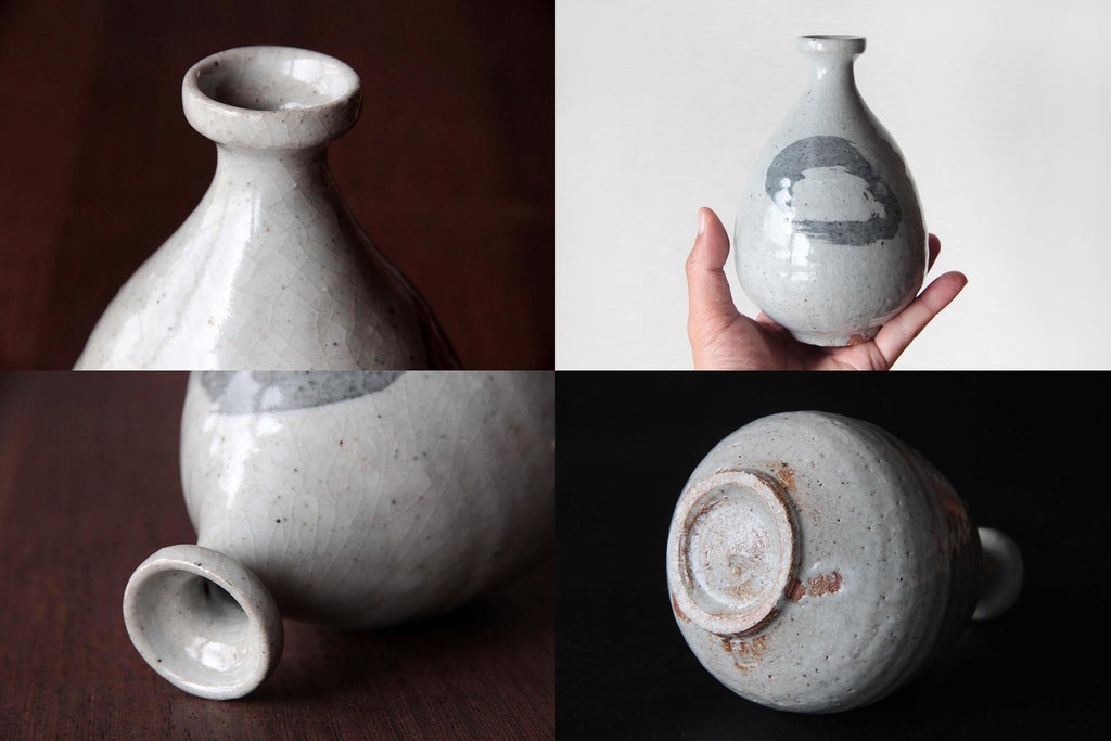 Big size Sake bottle with white glaze. Shopping the size by holding by hand.