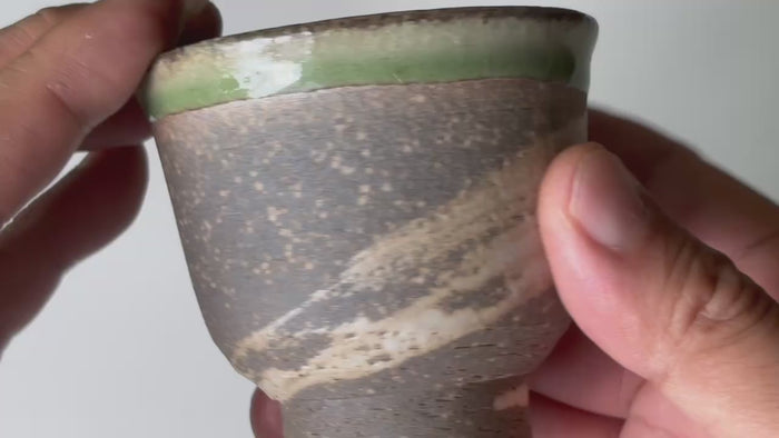 Rotating and close-up video showcasing the shape, texture, and details of the green glaze tea cup.