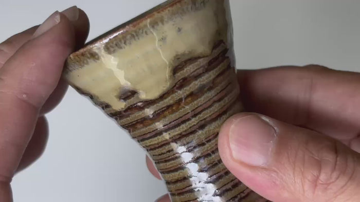 Rotating and close-up video showcasing the shape, texture, and details of the tall style ceramic cup.