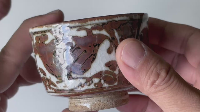 Rotating and close-up video showcasing the shape, texture, and details of the antique tea cup.