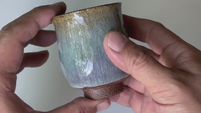 Rotating and close-up video showcasing the shape, texture, and details of the blue glaze tea cup.