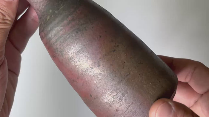Rotating and close-up video showcasing the shape, texture, and details of the unglazed brown bottle.