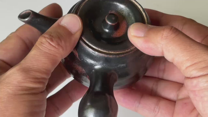 Rotating and close-up video showcasing the shape, texture, and details of the black glaze teapot.