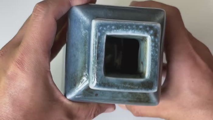Rotating and close-up video showcasing the shape, texture, and details of the blue vase.