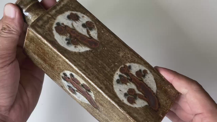Rotating and close-up video showcasing the shape, texture, and details of the artistic vase.