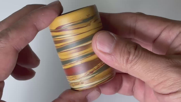 Rotating and close-up video showcasing the shape, texture, and details of the colorful small cup.