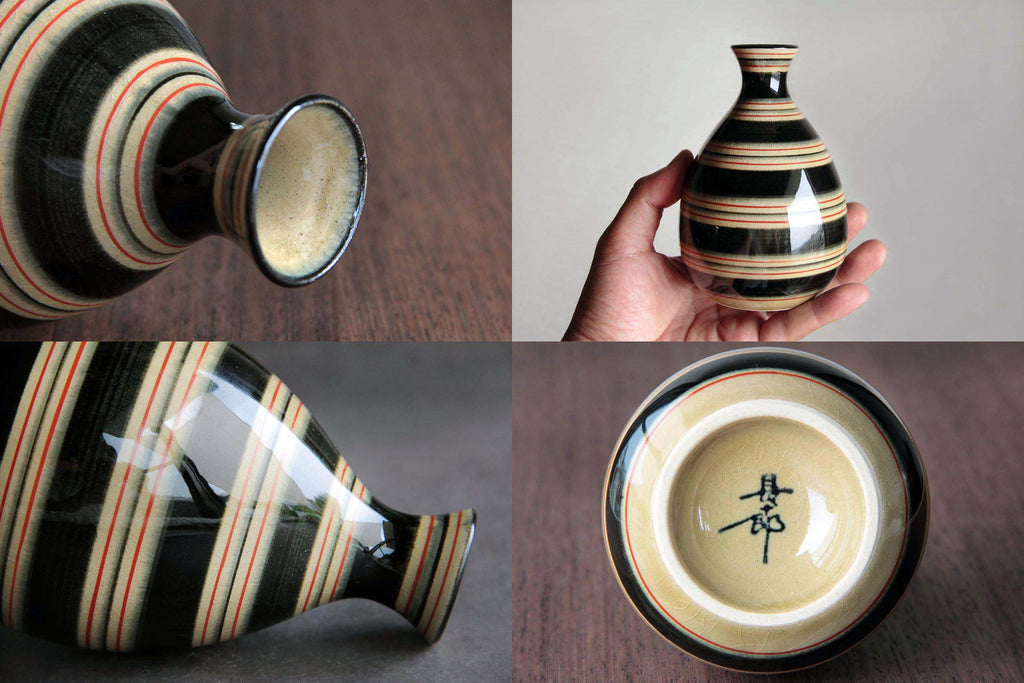 Hand holding a ceramic Tokkuri with bold horizontal stripe pattern,
showcasing its size and round body.