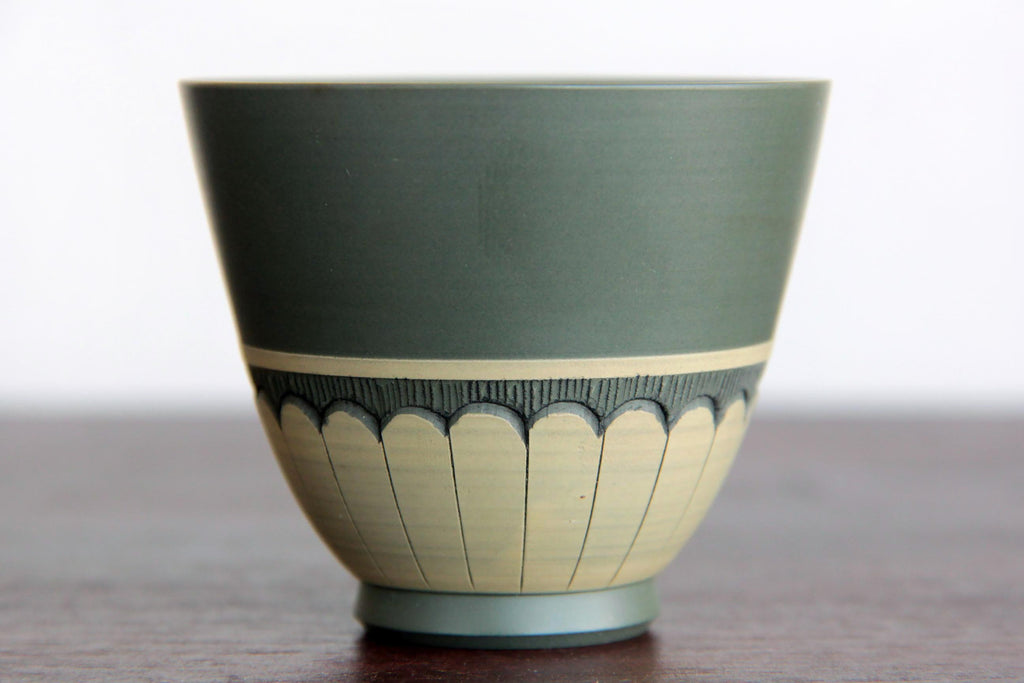 green Sake cup. Tokoname Yaki close-up photo.